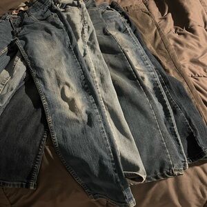 5 pairs of Classic Blue Denim Levis Jeans and a pair of gray Volvom pants.